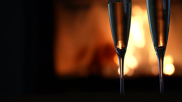 Two Glsses of Champagne in front of a Fireplace