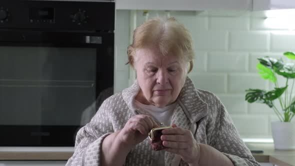 Senior Woman Opens Her Purse Sees That It is Empty and Gets Upset