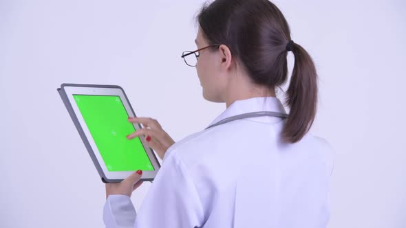 Rear View of Happy Young Woman Doctor Using Digital Tablet