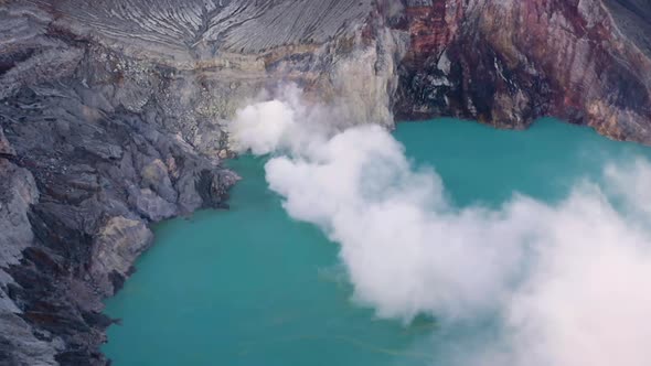 Crater of Ijen volcano, Java, Indonesia. Landscape with the green lake and the smoke