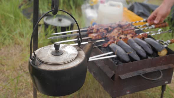 Old Teapot Boils on Campfires. Fire, Kettle, Camping. Set Fire To Boil Hot Water in the Kettle.