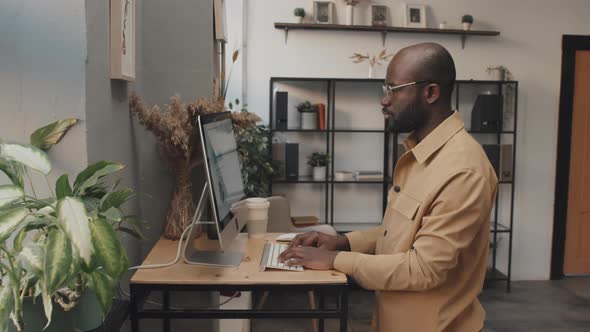 Man Typing on Computer