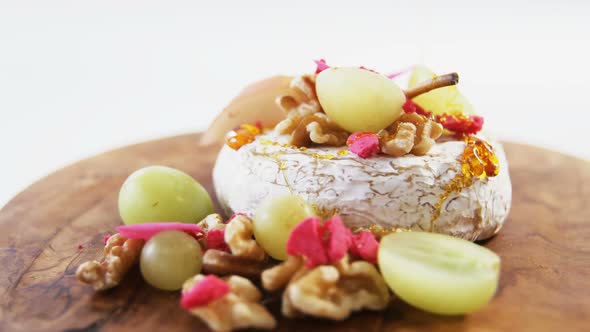Cheese dessert garnished with walnuts and grapes
