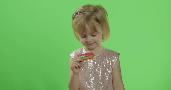 Girl in Glossy Dress Begins To Eat Cookies in the Form of Strawberries