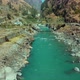 Beautiful Bhagirathi River flowing through small rocks under small green bridge - VideoHive Item for Sale