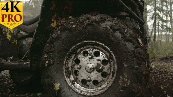 The Muddy Left Wheel of the Offroad Vehicle