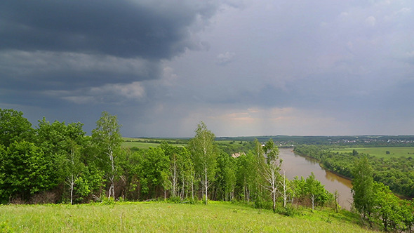 Landscape With River And Rain On Horizon