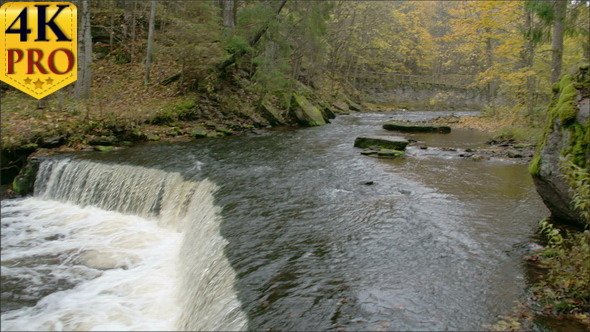 A Lake With a Small Waterfall on the End