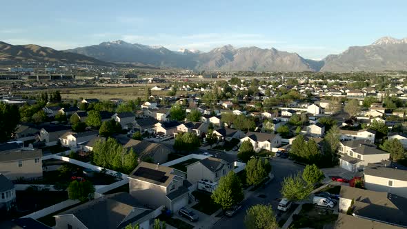 Single family homes in a typical suburban neighborhood in a valley below the Rocky Mountains - panor