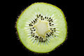 Macro of slim sliced kiwi fruit on black background - PhotoDune Item for Sale