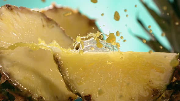 Slow Motion Shot of Pineapple and Juice Splashing Through Pineapple Slices