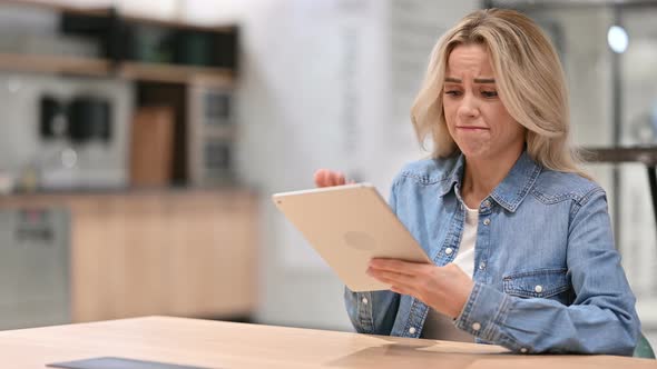 Online Video Chat on Tablet By Young Casual Woman at Work 