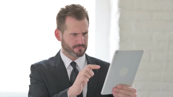 Young Businessman Having Loss on Tablet in Office