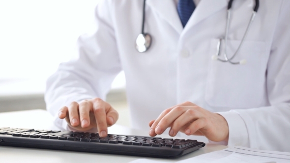 Male Doctor Hands Typing On Keyboard