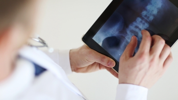 Doctor With X-ray Scan On Tablet Pc