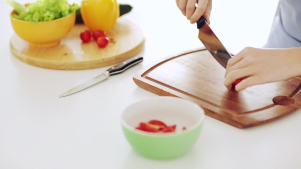 Woman Chopping Vegetables At Home