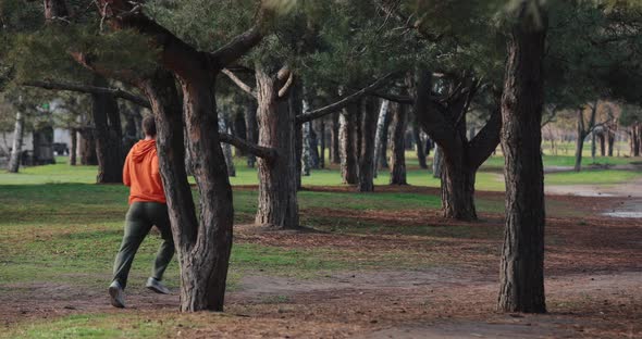 A Man Jogging Running in a Park Slow Motion Back View