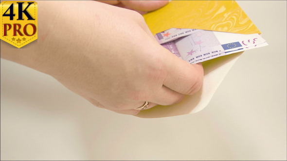 A Lady Hand Counting the Euro Bills Inside the Env