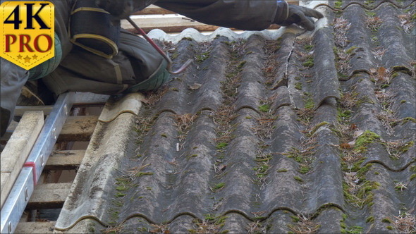A Roofer is Getting Off the Nails from the Roof Pl