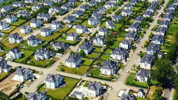 Street with new homes in spring season. Single family houses and residential construction planned co