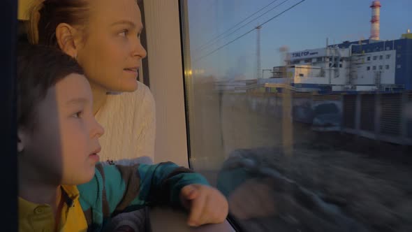 In Saint-Petersburg, Russia in train rides a young mother with a son and looking out the window