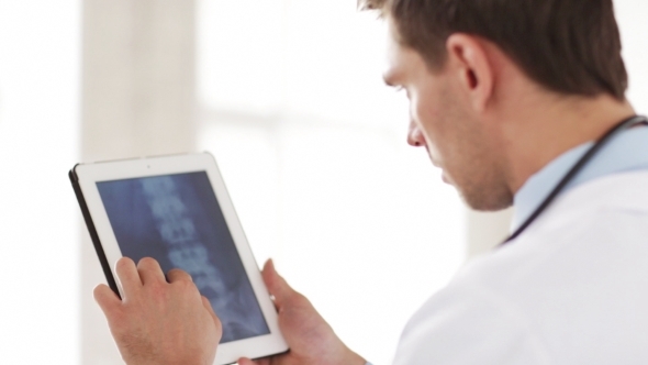 Doctor With X-ray Scan On Tablet Pc