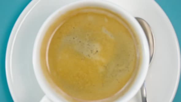 Cup with Coffee on Saucer on Table