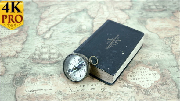 A Compass and a Book on a Map