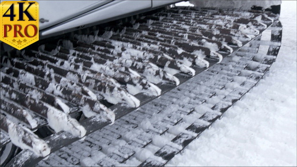 The Large Wheel of a Back Hoe that Gets Snow alt