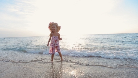 Little Girl Jumping In The Sea Water And Runs To