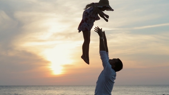 Father Throws Up In The Air Little Happy Girl Near