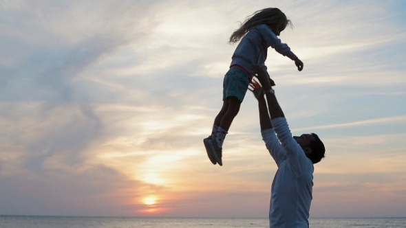 Father Throws Up In The Air Little Happy Girl Near