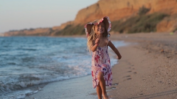 Little Girl Running Along The Beach Leaving