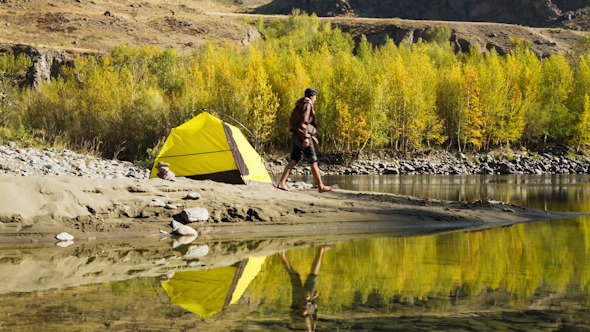 Man Setting Up his Tent for Camping 