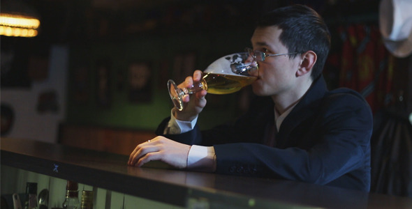 Businessman Drinking Beer in the Pub