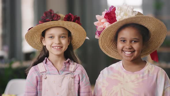 Adorable Children in Straw Hats with Flowers Smiling