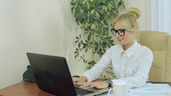 Beautiful Secretary Working At a Computer