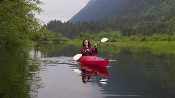 Adventure Caucasian Adult Woman Kayaking in Red Kayak