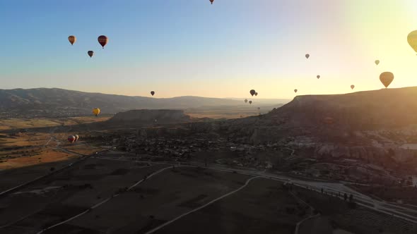 Aerial Hot Air Balloons Flying Over Hoodoos Fairy Chimneys in Cappadocia Turkey at Sunrise Morning