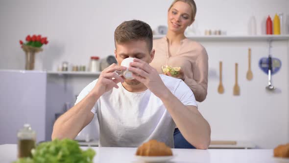 Lady Playfully Feeding Husband With Slice of Banana, Fruits as Tasty Vitamins