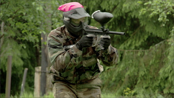 A Man Walking with the Shooting Paintball