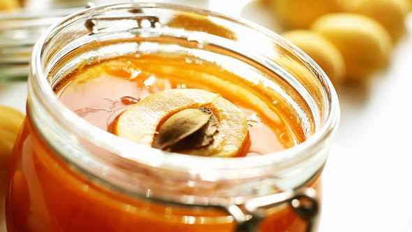 Slices Of Fresh Apricot Fall Into A Jar