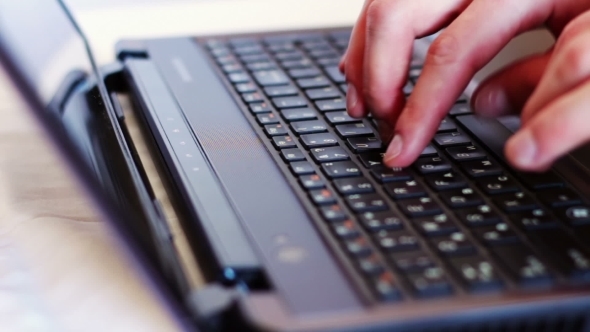 Man Typing On Laptop Keyboard.