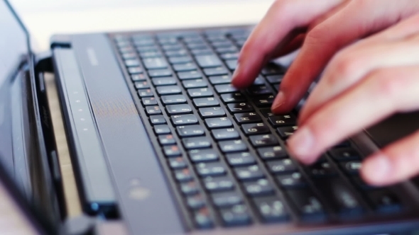 Man Typing On Laptop Keyboard.