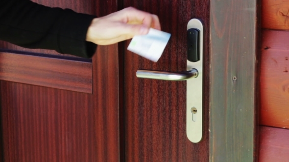 The Man Opens The Door To An Electronic Key - Card