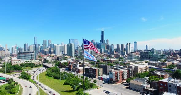 Aerial Drone Shot of Chicago Downtown Above the Highway with American Flag