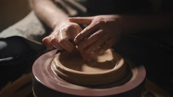 Artisan Hands Forming a Plate From Clay on a Potter's Wheel in Slow Motion