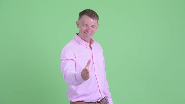 Portrait of Happy Businessman Giving Handshake