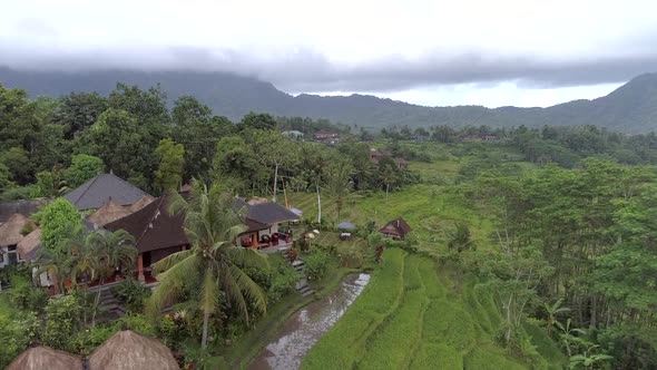 Aerial view of small straw bungalow neighborhood, Bali island, Indonesia.