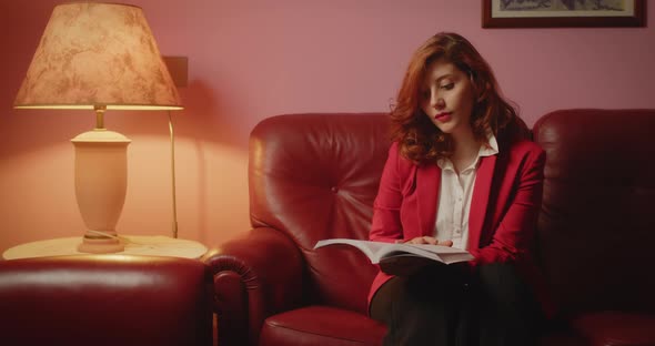 Beautiful girl with red jacket reads the book